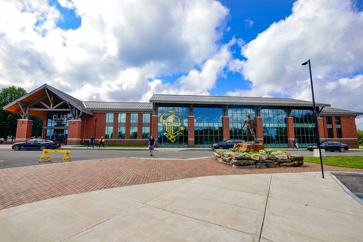 Exterior of Clarkson University's Cheel Area with surrounding sidewalks and parking lot.