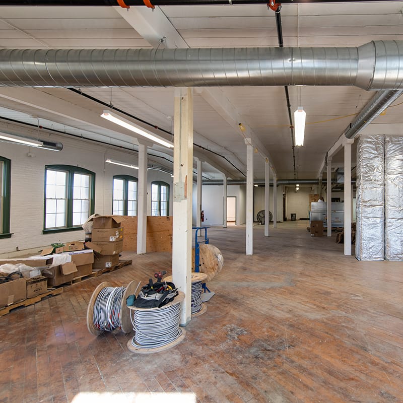 Interior view of 558 River Street; Hardwood floors, columns and arched windows.